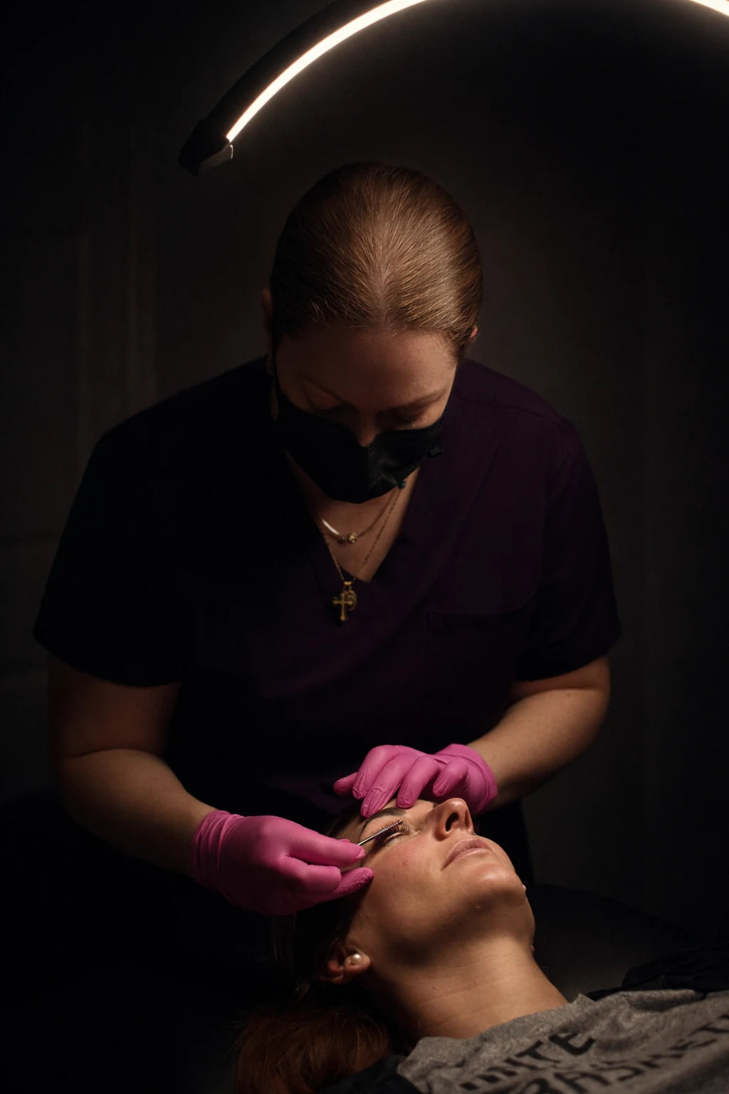 A Body by Shae esthetician performing a lash treatment