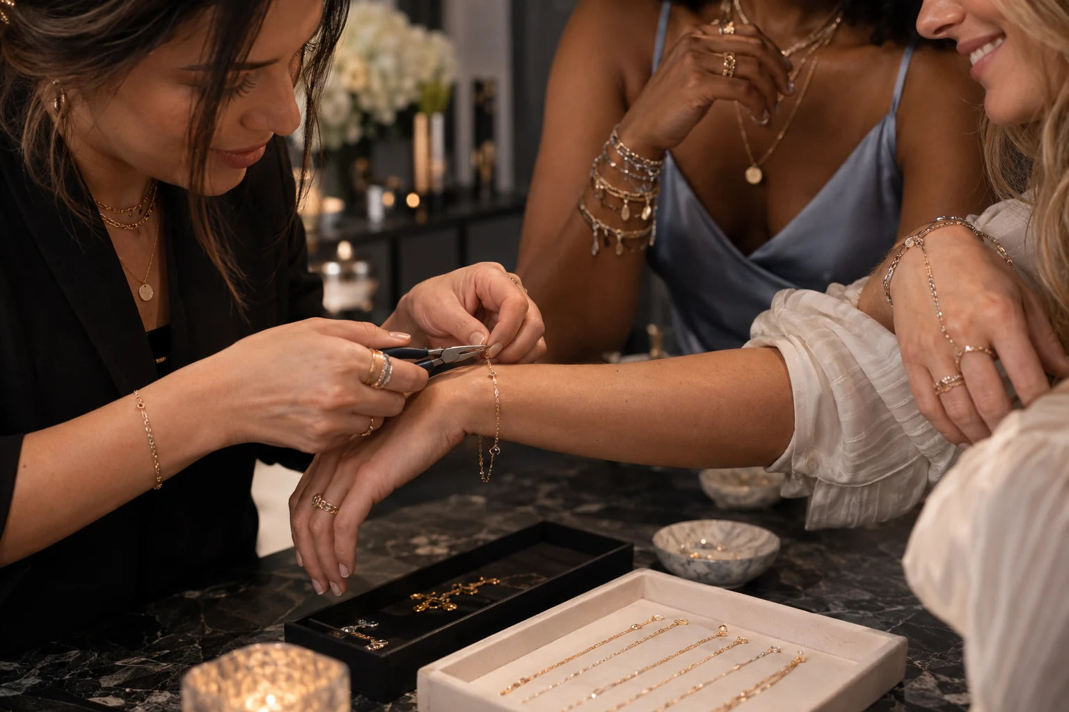 Illustrative private jewelry party with custom bracelet fitting, hand chains and stacks