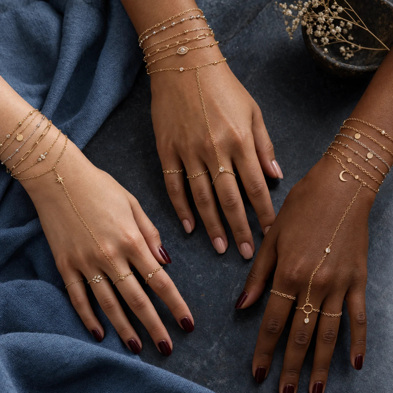 Jewelry styling inspiration with diverse hands, bracelets, charms and rings